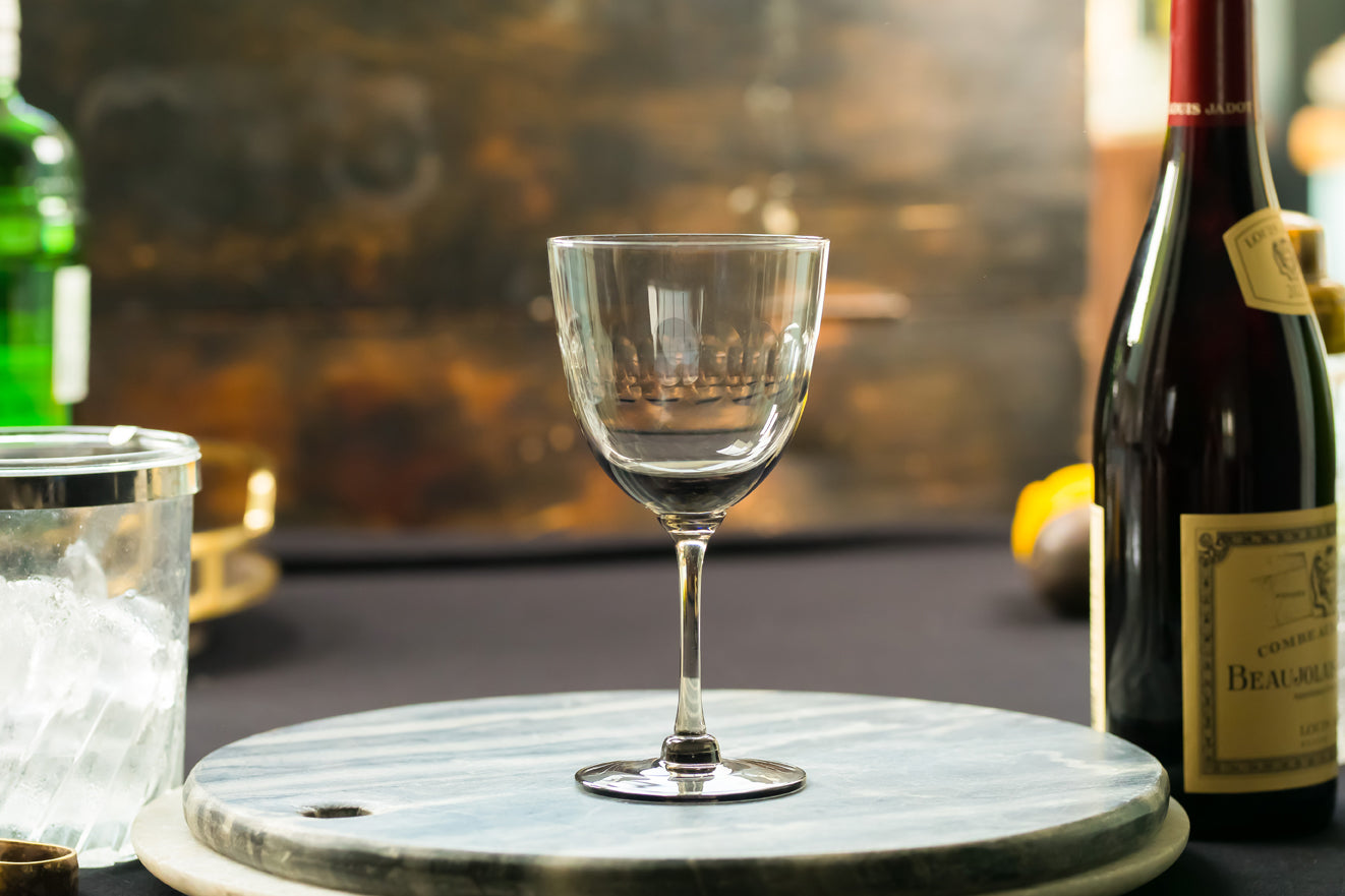 four smoky crystal wine glasses with lens design