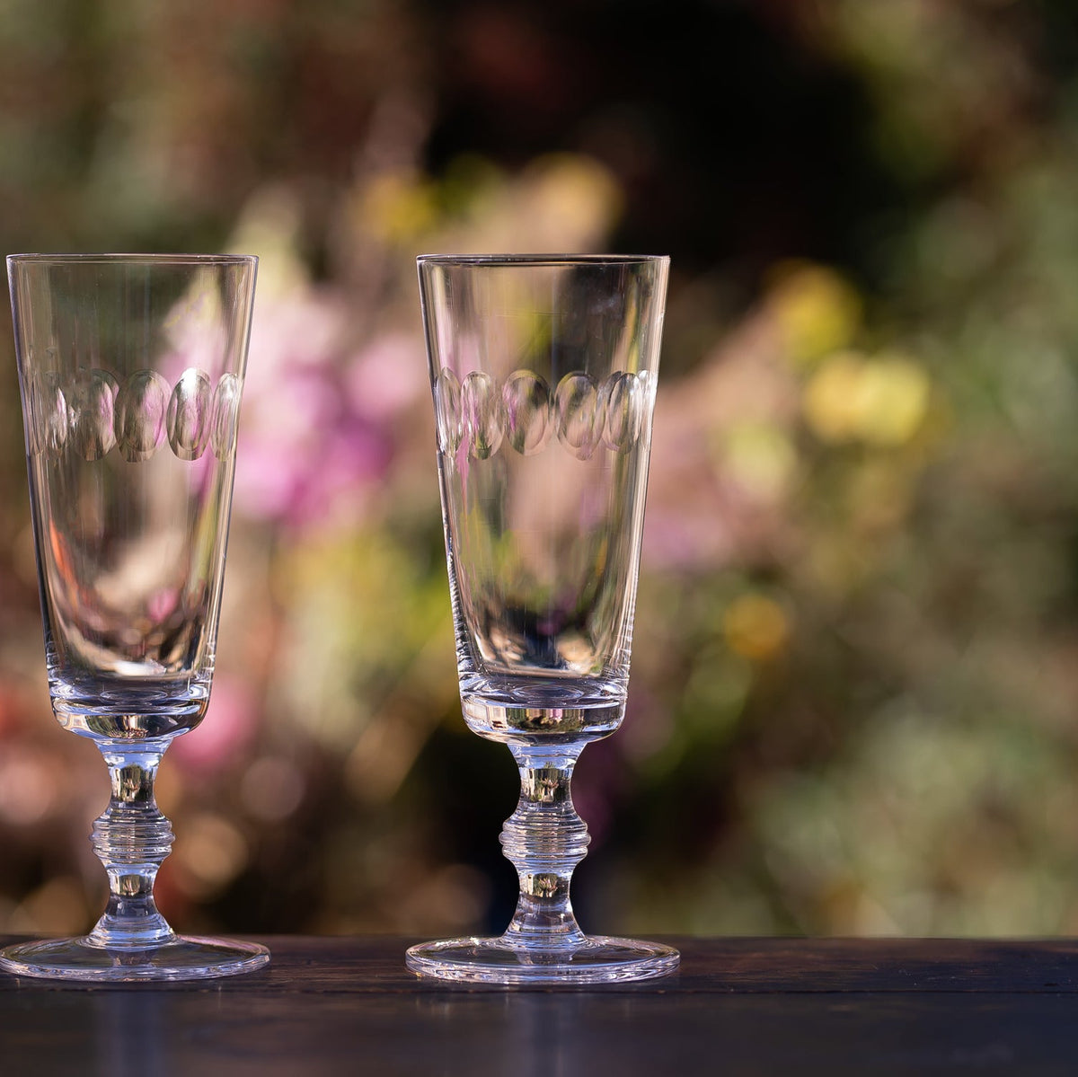 A Set of Four Crystal Champagne Flutes with Lens Design