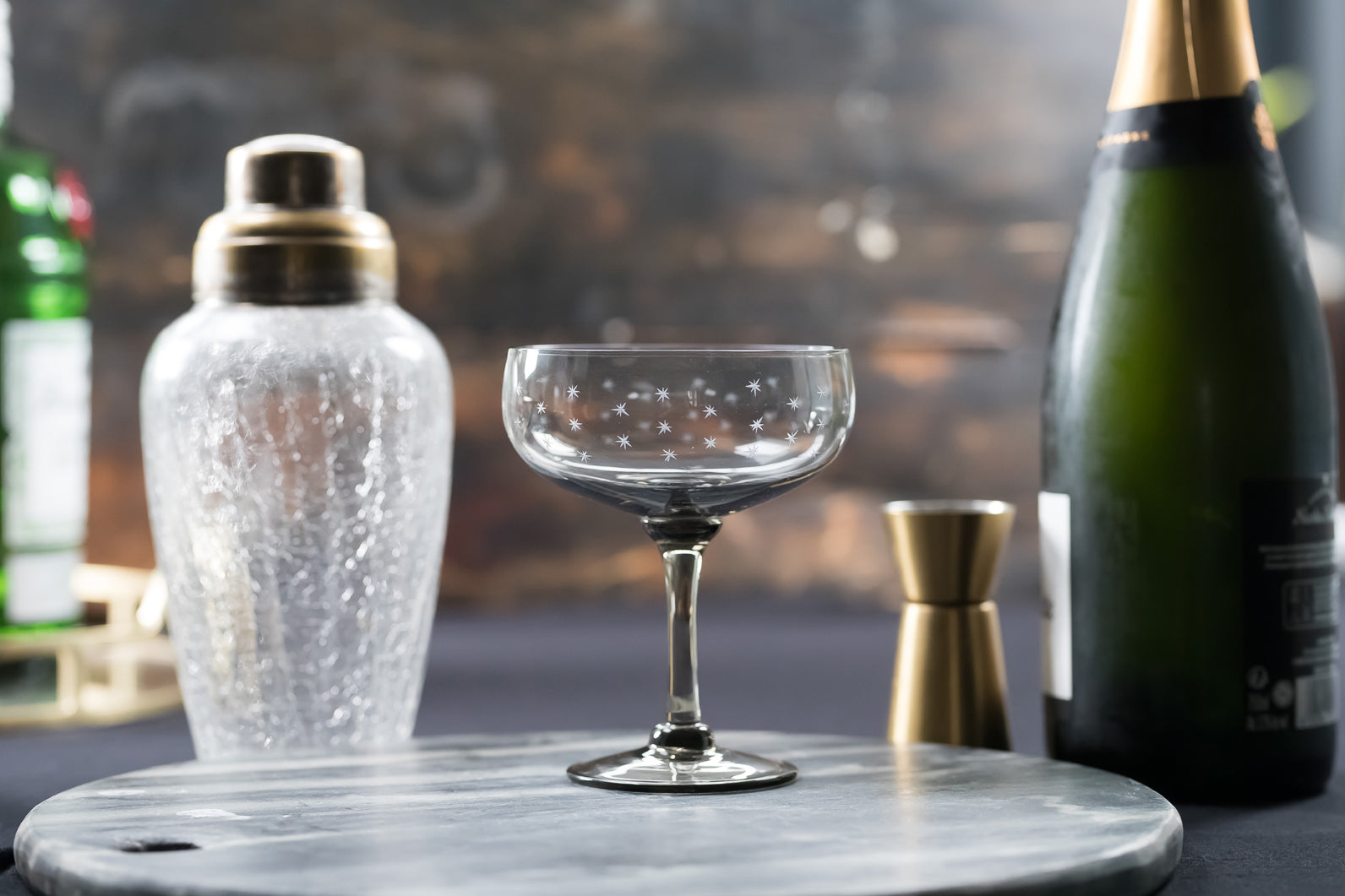 four smoky crystal cocktail glasses with stars design