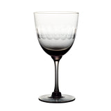 four smoky crystal wine glasses with lens design