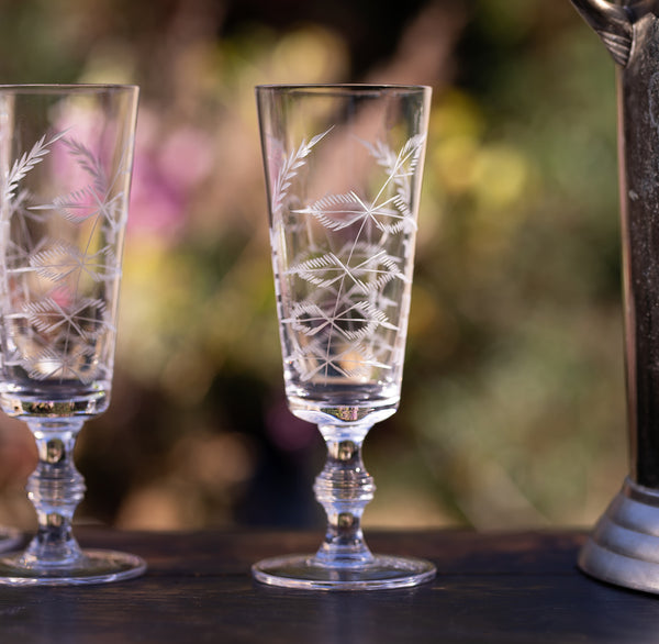 A Set of Four Crystal Champagne Flutes with Fern Design