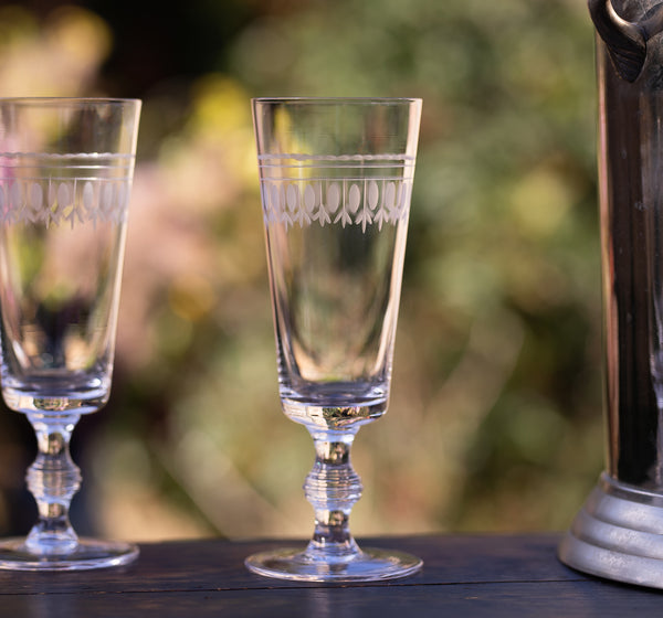 A Set of Four Crystal Champagne Flutes with Ovals Design